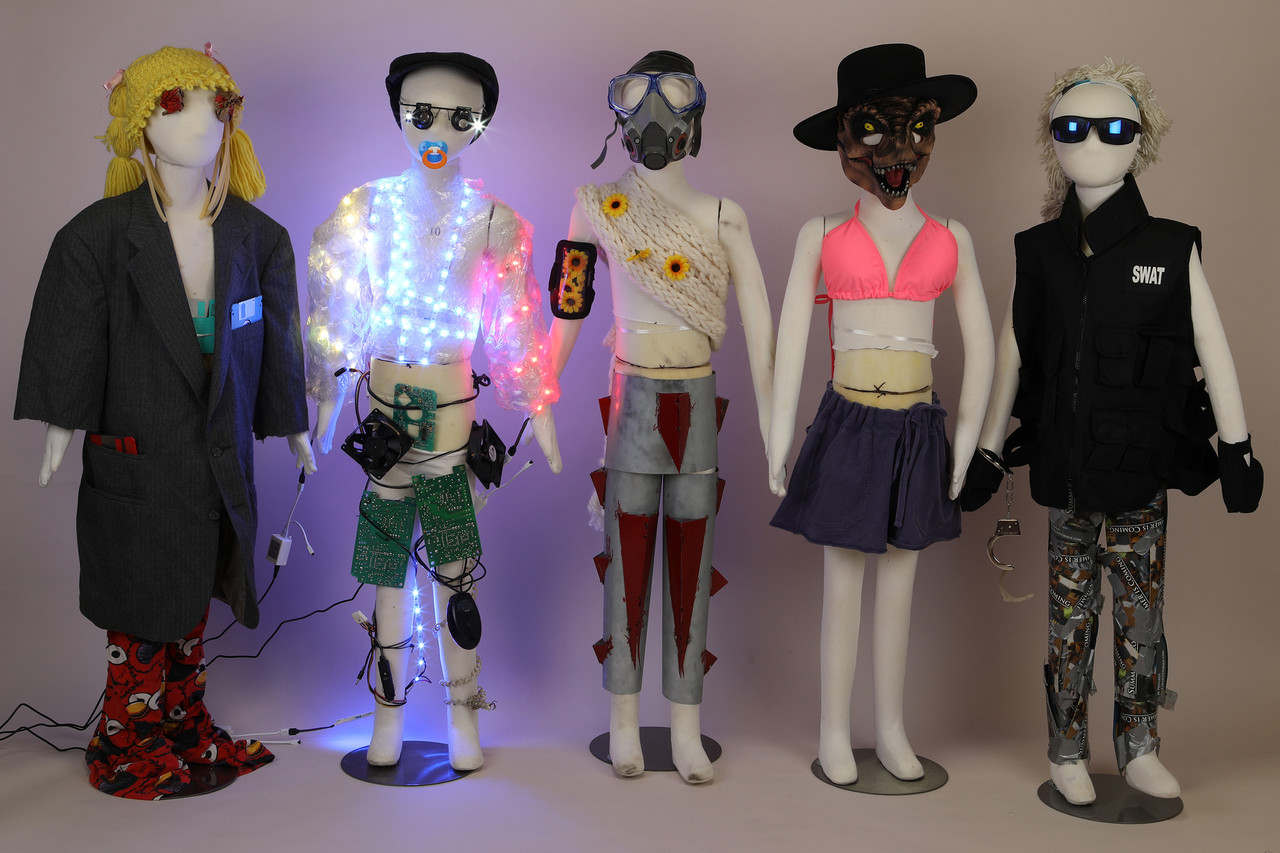 Five child mannequins built into different characters with light and wiring